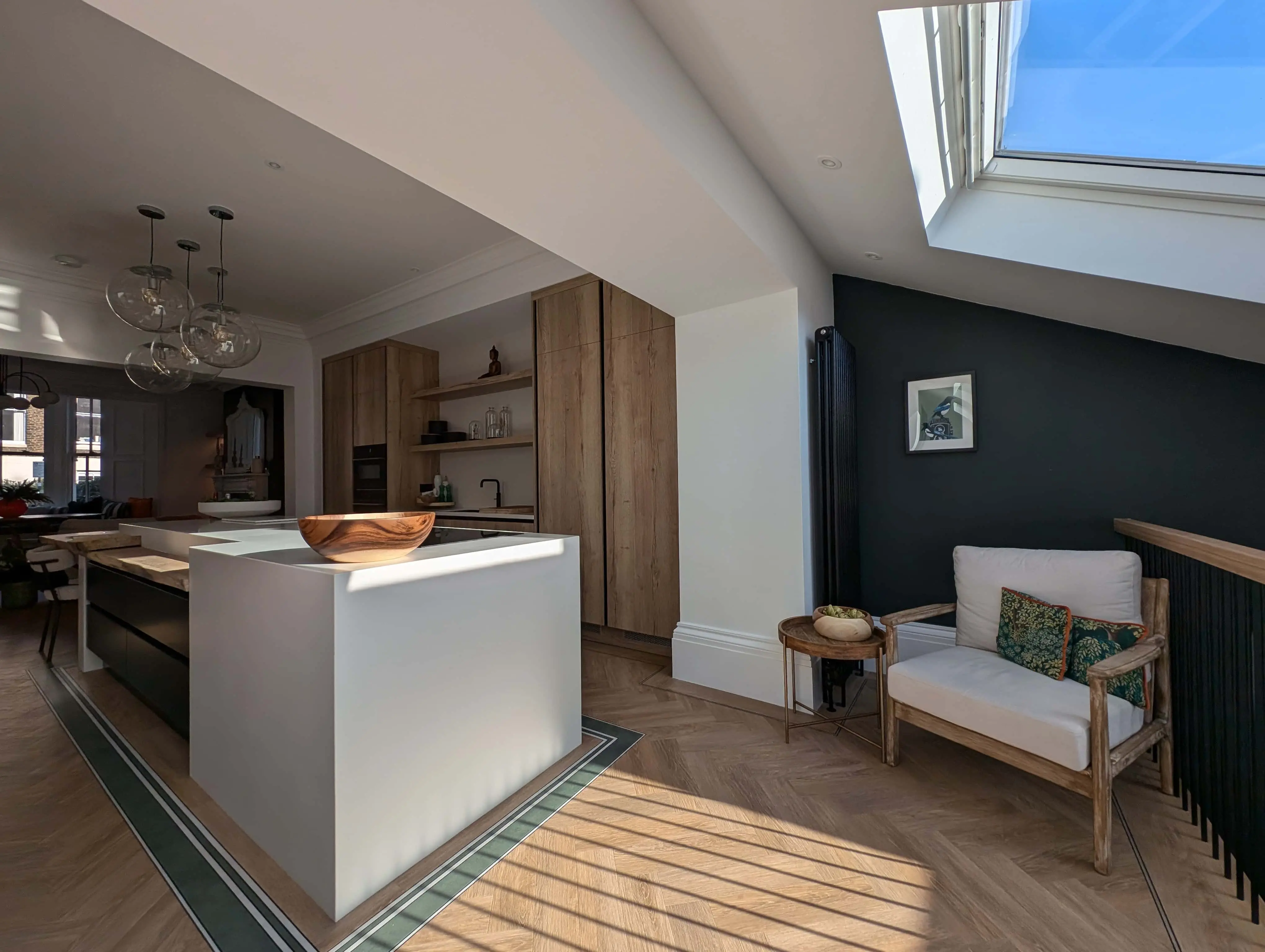 carlton-terrace-open-plan-kitchen-living-skylight-acre-design.webp Open-plan kitchen and living space with skylight, bespoke island and seating area in Carlton Terrace townhouse renovation by Acre Design