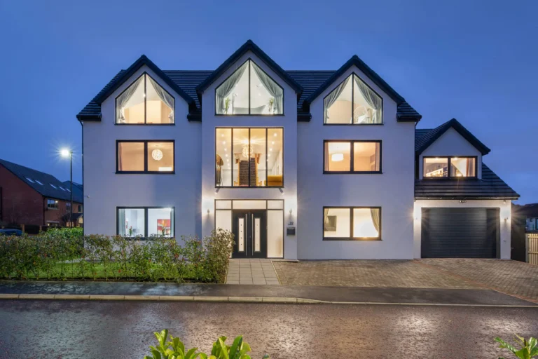Gosforth Great Park home at night with warm light from inside