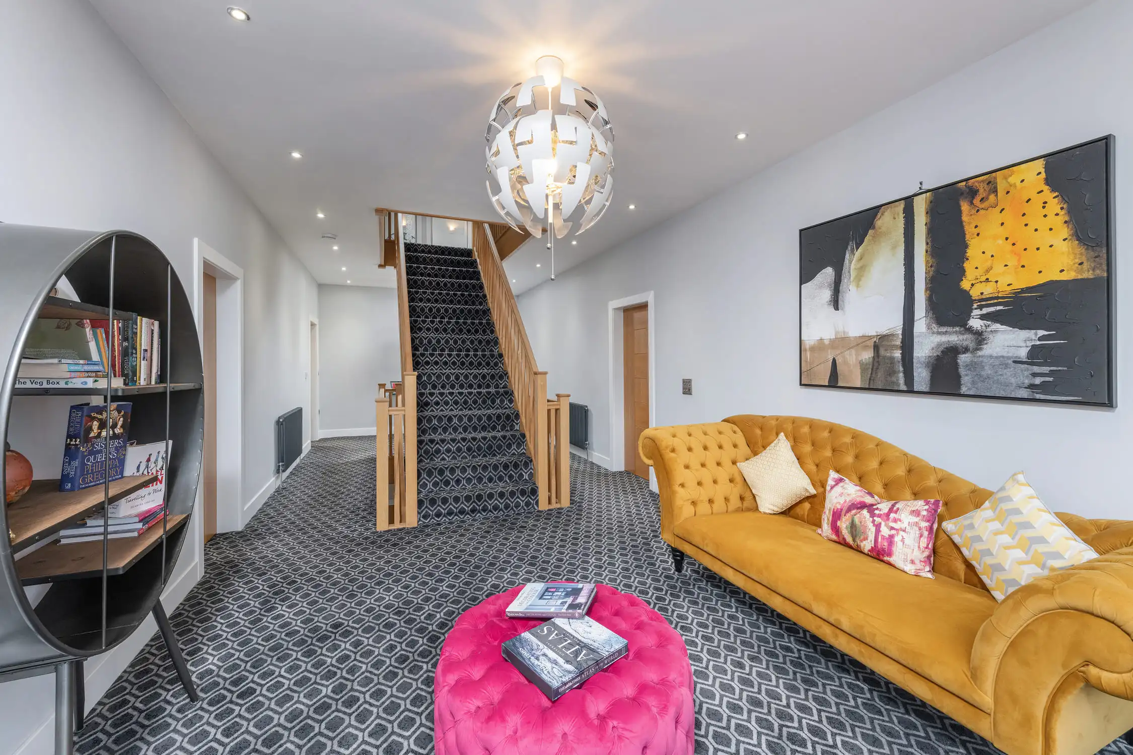 Hazelwood-Road-Great-Park-Gosforth-Newcastle-Self-Build-Home-Design-Acre-vibrant-hallway-seating-velvet-couches-sofas-modern Large self build home designed by Acre Design Newcastle on Hazelwood Road, Great Park. Large hallway space featuring velvet furnishings in striking mustard and pink colours. Large oak staircase.