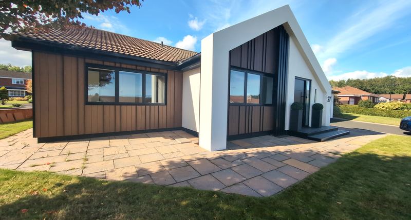 Redesigned bungalow in Washington with vertical timber cladding and a glazed gable end