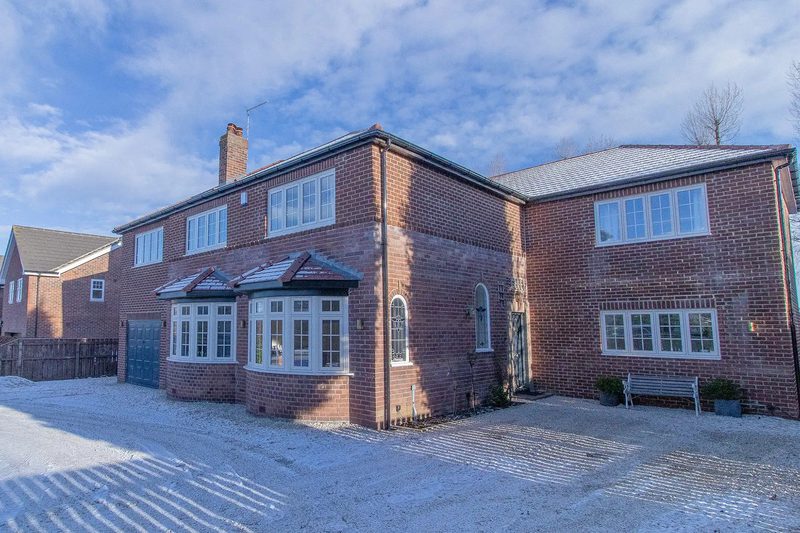 Front of a brick family home at Darras Hall, Northumberland, after an extension and major reconfiguration