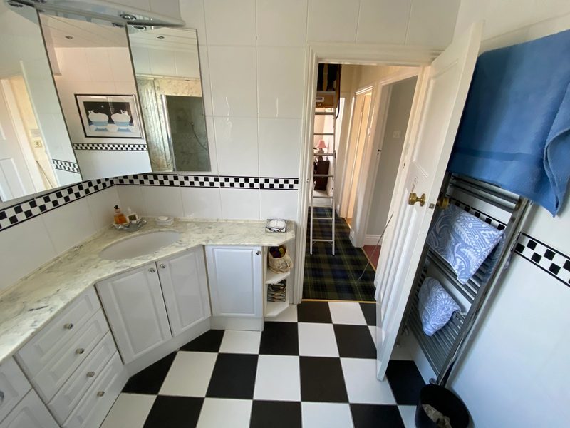 Original narrow kitchen with chequered floor tiles at a Sunderland home before its renovation