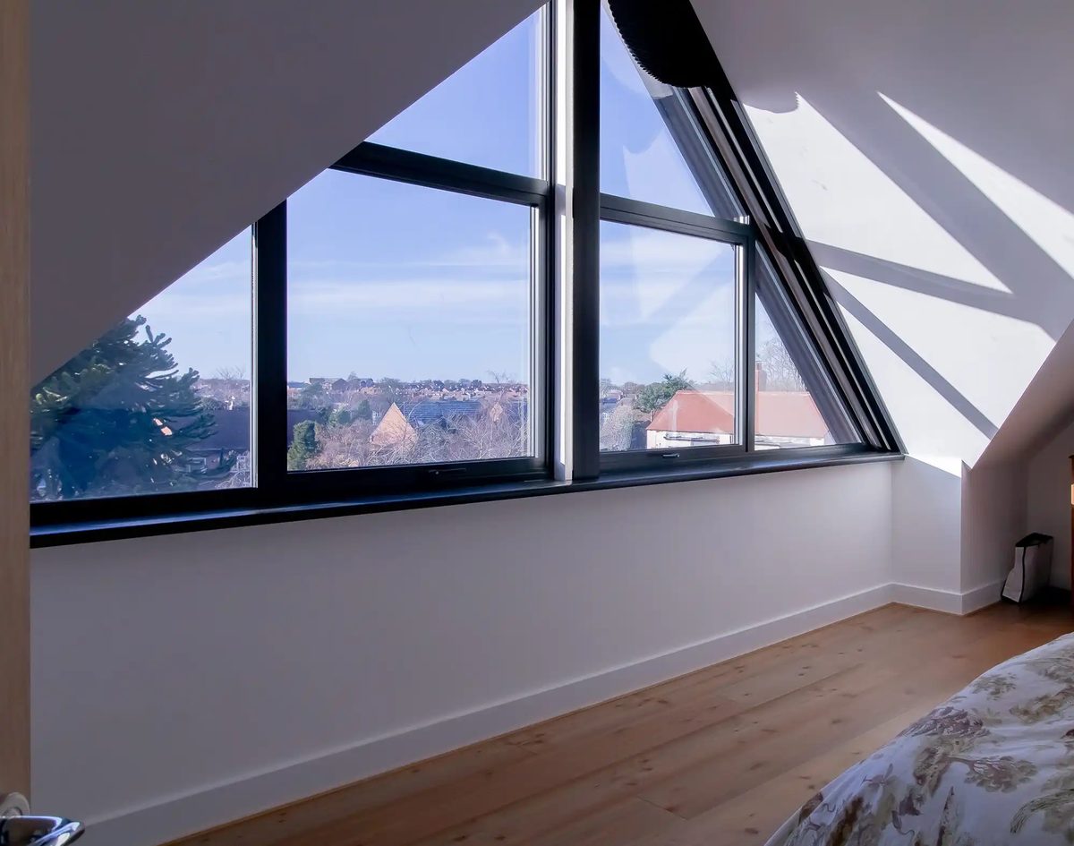 Loft conversion with apex glazing and views over the rooftops at a period home in Monkseaton, North Tyneside