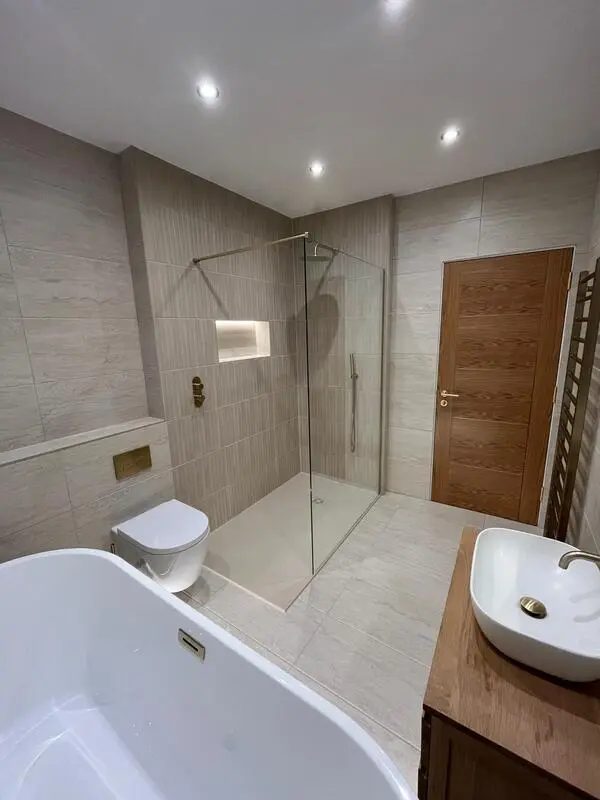 Completed bathroom with a walk-in shower and freestanding bath at a Sunderland home with a loft conversion