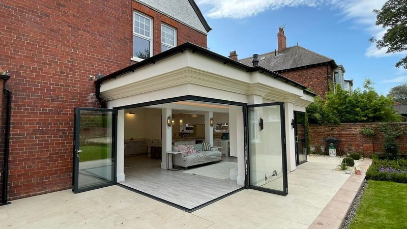 Completed orangery-style rear extension in Whitley Bay with corner glazing opening onto the patio