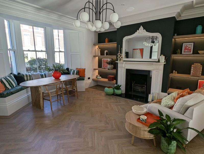 Renovated period living room with a restored fireplace and built-in shelving in a historic Newcastle home